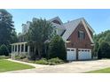 Lovely brick home featuring an attached two-car garage, manicured landscaping, and a beautiful front porch at 3732 Sparrow Pond Ln, Raleigh, NC 27606