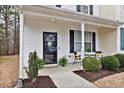 Inviting front porch with seating area and black trimmed front door at 3924 Volkswalk Pl, Raleigh, NC 27610