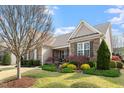 Landscaped front yard featuring lush greenery, flowering bushes, and well-kept lawn at 4014 Peeler Ct, Rolesville, NC 27571