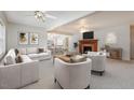 Bright living room featuring contemporary furniture, a fireplace, and an open-concept view to the kitchen at 410 E Mcneill St, Lillington, NC 27546