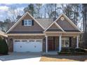 Attractive brick home with dormer windows, landscaped yard, and a red front door adorned with a wreath at 430 Easy Wind Ln, Garner, NC 27529