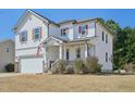 Beautiful two-story home with manicured lawn, appealing shutters, and a cozy, covered front porch at 505 Ferry Ct, Wake Forest, NC 27587
