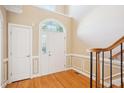 Inviting foyer with high ceilings, hardwood floors, and a stairway with a wooden handrail at 508 Spencer Crest Ct, Cary, NC 27513