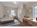 Comfortable bedroom with a bed, a desk, wood floors, and a calm atmosphere at 516 Craven Road, Durham, NC 27704