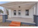 Inviting front porch with classic columns and wood steps leading to the entrance at 516 Craven Road, Durham, NC 27704