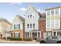 Charming townhouse with brick and siding exterior, manicured landscaping, and covered entrance at 627 Balsam Fir Dr, Cary, NC 27519