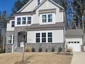 Beautiful two-story home with stone accents, bright windows, a well-kept lawn, and attached garage at 664 The Parks Dr, Pittsboro, NC 27312
