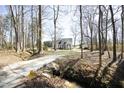 Secluded house with a long driveway surrounded by tall trees at 7127 Lark Ln, Sanford, NC 27332