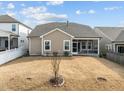 The backyard features a simple, grassy yard and a screened in patio area at 721 Sage Oak Ln, Holly Springs, NC 27540