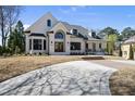 Attractive home boasts well-kept landscaping, a circular driveway, and a welcoming entrance at 7217 Manor Oaks Dr, Raleigh, NC 27615