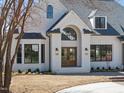 Close-up view of the home's entry, showcasing its stylish double doors and brick walkway at 7217 Manor Oaks Dr, Raleigh, NC 27615