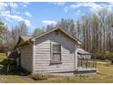 Side view of a simple one-story home with basic siding and a small porch at 7534 Overhills Rd, Spring Lake, NC 28390