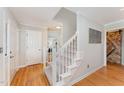 Foyer with hardwood floors, staircase, and access to the living areas with a view of the barn door at 8 Bryncastle Ct, Durham, NC 27707