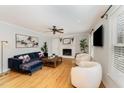 Spacious living room features hardwood floors, fireplace, and ample natural light with a ceiling fan at 8 Bryncastle Ct, Durham, NC 27707