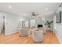 Cozy living room with hardwood floors, fireplace, and a stylish seating arrangement at 8 Bryncastle Ct, Durham, NC 27707