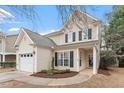 Inviting home with a two-car garage, manicured front lawn, and cozy front porch at 8412 Lunar Stone Pl, Raleigh, NC 27613