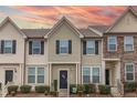 Charming townhouse featuring a neatly landscaped front yard and complementary exterior color scheme at 9845 Sweet Basil Dr, Wake Forest, NC 27587