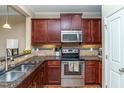 Well-equipped kitchen with stainless steel appliances, granite countertops, and ample cabinet space at 9845 Sweet Basil Dr, Wake Forest, NC 27587