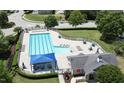 Aerial view of the community pool with lounge chairs and a shaded picnic area at 9845 Sweet Basil Dr, Wake Forest, NC 27587