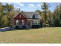Charming two-story home with a mix of brick and siding, surrounded by mature trees at 1001 Jarrett Bay Rd, Willow Springs, NC 27592