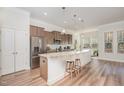 Modern kitchen featuring stainless steel appliances, granite countertops, and a large island at 1001 Jarrett Bay Rd, Willow Springs, NC 27592