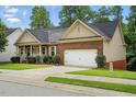 Well-maintained single-story home featuring brick and siding, an attached garage, and a tidy front lawn at 1056 Lukestone Dr, Fuquay Varina, NC 27526
