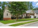 Well-maintained single-story home featuring brick and siding, an attached garage, and a tidy front lawn at 1056 Lukestone Dr, Fuquay Varina, NC 27526