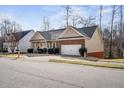 A side angle view of a single Gathering home with brick and siding at 1056 Lukestone Dr, Fuquay Varina, NC 27526