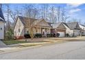 An angled view showing the front porch and two-car garage at 1056 Lukestone Dr, Fuquay Varina, NC 27526