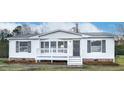 Inviting home with a covered front porch and well-maintained yard at 110 Hickory Dr, Spring Hope, NC 27882