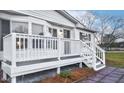 A front porch with white railings and steps for the entry to the home at 110 Hickory Dr, Spring Hope, NC 27882