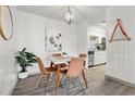 Dining area featuring a stylish table, four chairs, modern lighting, and wood-look floors at 1110 Schaub Dr # B, Raleigh, NC 27606