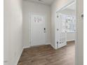 Bright entryway features wood-look flooring, a white front door with windows, and an open view into the living space at 116 Pisgah, Sanford, NC 27330