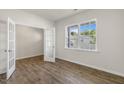 Bright living space features wood-look flooring, a large window with backyard view, and a modern French door at 116 Pisgah, Sanford, NC 27330