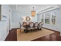 Elegant dining room with hardwood floors, decorative lighting fixture, and ample natural light at 126 Filigree Way, Durham, NC 27713