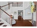 Elegant foyer boasts hardwood floors, a staircase, and open access to other rooms at 126 Filigree Way, Durham, NC 27713