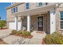 Charming front porch with columns and a welcoming entryway featuring a decorative wreath at 126 Filigree Way, Durham, NC 27713