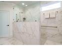 Elegant bathroom showcases marble shower with glass enclosure and gold fixtures at 127 Gadwall Ln, Durham, NC 27703
