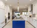 Bright kitchen features white cabinets, large island with stylish pendant lighting at 127 Gadwall Ln, Durham, NC 27703