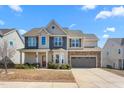 Charming two-story home with stone accents and covered porch at 130 Campaign Dr, Mebane, NC 27302