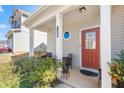 Inviting front porch with seating area and red front door at 130 Campaign Dr, Mebane, NC 27302