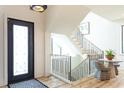 Bright foyer showcases a modern staircase, stylish lighting, and a chic seating area at 1323 Ridge Rd, Raleigh, NC 27607