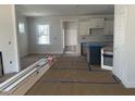 Open-concept kitchen and dining area with white cabinets and an island, under construction at 1448B Maplewood Dr, Durham, NC 27704
