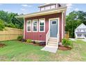 Charming home featuring a landscaped front yard, new exterior paint and modern windows at 1448C Maplewood Dr, Durham, NC 27704