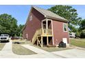Side view of home with craftsman trim and a small wooden deck at 1448C Maplewood Dr, Durham, NC 27704