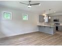 Open concept living and kitchen area boasts wood flooring and modern fixtures at 1448C Maplewood Dr, Durham, NC 27704