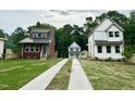 Charming street view showcasing three homes with modern designs, manicured lawns, and inviting driveways at 1448C Maplewood Dr, Durham, NC 27704