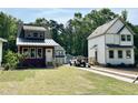 Street view of three homes with craftsman trim, metal roofs and neatly manicured lawns at 1448C Maplewood Dr, Durham, NC 27704