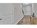 Light and airy entryway with hardwood floors, leading to staircase and front door at 1776 Golden Honey Dr, Wake Forest, NC 27587