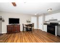 Open-concept space with wood floors, TV, dining area, and access to the kitchen at 2011 Quaker Lndg # 101, Raleigh, NC 27603